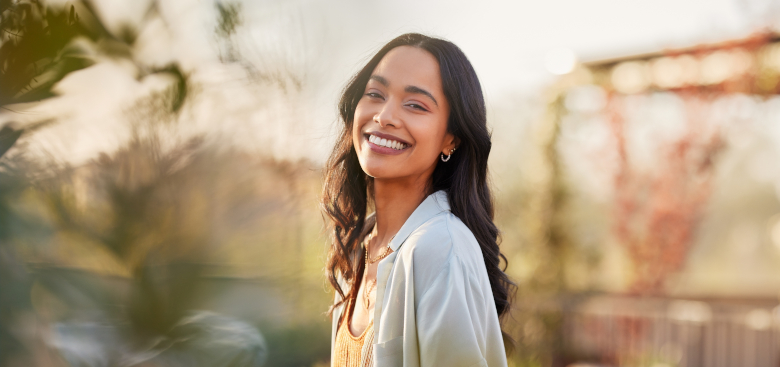 Portrait of beautiful happy woman smiling during sunset outdoor