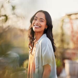 Portrait of beautiful happy woman smiling during sunset outdoor